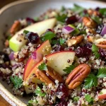Close-up view of a vibrant quinoa apple salad with colorful ingredients.