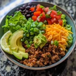 A close-up view of a vibrant Keto Taco Salad Bowl with colorful ingredients.