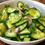 Close-up view of a creamy cucumber dill salad featuring fresh ingredients.