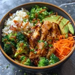 Close-up of a serving of teriyaki chicken bowl with chicken thighs, rice, and vegetables.