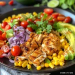 Close-up of a vibrant avocado corn chicken salad with fresh ingredients.