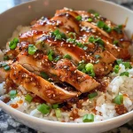 A close-up side view of Honey BBQ Chicken Rice in a bowl, showcasing juicy chicken pieces and rice.