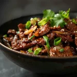 Close-up view of a vibrant Chinese Beef and Onion Stir-Fry featuring sliced beef and caramelized onions.