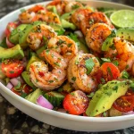 Close-up of a vibrant avocado shrimp salad, showcasing juicy shrimp and fresh vegetables.