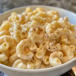 Close-up of creamy macaroni and cheese with a golden crust.