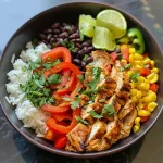 Close-up of a colorful chicken burrito bowl with fresh vegetables and toppings.