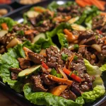 Close-up of Korean Beef Lettuce Wraps with colorful vegetables.