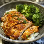 Close-up view of meal prep containers with chicken, rice, and broccoli.