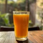 Close-up view of Metabo Slim Juice in a glass with green tea extract and fruit.