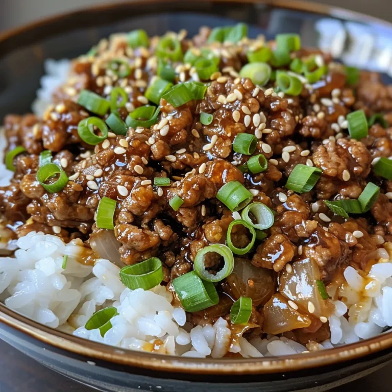 Juicy teriyaki ground beef garnished with sesame seeds and sliced green onions.
