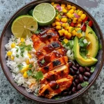 Juicy BBQ chicken bowls featuring sliced avocado, black beans, and corn.