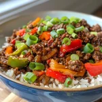 Close-up view of a Beef and Pepper Rice Bowl with colorful diced peppers and ground beef.