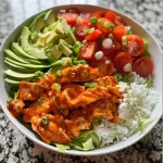 Close-up of a vibrant Buffalo Chicken Bowl with colorful ingredients.