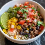 Close-up view of a juicy beef burrito bowl with colorful toppings.