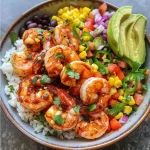 Close-up view of a Fiesta Shrimp Rice Bowl with colorful ingredients.