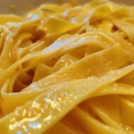Close-up of gluten-free egg noodles with a shiny, appealing texture.