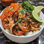 A vibrant rice bowl filled with grilled shrimp, colorful mixed vegetables, and garnished with lime wedges and cilantro.