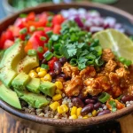 Close-up view of a colorful chicken enchilada bowl with quinoa and various vegetables.