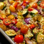 Close-up view of a bowl of quinoa mixed with colorful roasted vegetables, highlighting the textures.