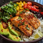 Close-up view of a Salmon Burrito Bowl filled with colorful ingredients.