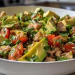 ['Close-up of a vibrant Lemony Avocado Tomato Tuna Salad with fresh ingredients visible.', 'Side view of a colorful salad featuring tuna, diced avocado, and cherry tomatoes.', 'Juicy Lemony Avocado Tomato Tuna Salad highlighted with fresh herbs and green onions.', 'Detailed shot of a refreshing tuna salad with creamy avocado and sliced tomatoes.']