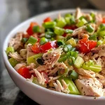 ['Close-up view of a vibrant turkey salad featuring diced turkey, celery, green onions, and red bell pepper in a creamy dressing.', 'Side angle photo of a fresh turkey salad with chopped vegetables and a creamy mayonnaise dressing, displayed in a bowl.', 'Juicy turkey salad made with fresh vegetables, showcasing the ingredients like celery and red bell pepper in a close-up shot.', 'Detail shot of a colorful turkey salad with cooked turkey, green onions, and bell pepper, highlighted against a blurred background.']