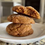 ['Close-up of chewy pumpkin cookies with a golden-brown exterior and a soft, textured surface.', 'Side view of freshly baked pumpkin cookies, showcasing their chewy texture and warm orange hue.', 'Juicy pumpkin cookies arranged on a plate, highlighting their inviting softness and rich color.', 'A detailed view of delicious chewy pumpkin cookies, emphasizing their warm, inviting appearance.']