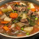 ['Close-up of a hearty vegetable beef soup with chunks of vegetables and ground beef.', 'Side view of a bowl filled with colorful vegetable beef soup garnished with parsley.', 'Delicious Easy Vegetable Beef Soup showcasing diced vegetables and tender meat.', 'A rich, steaming bowl of vegetable beef soup, filled with vibrant ingredients.']