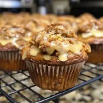 ['Close-up view of glazed apple coffee cake muffins with a glossy finish.', 'Side view of a stack of moist glazed apple muffins, showing the apple chunks.', 'Juicy apple coffee cake muffins sprinkled with a light glaze, highlighting their texture.', 'Irresistible glazed muffins filled with apple pieces, showcasing a crumbly top.']