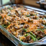 ['Close-up view of a Hamburger Green Bean Casserole with ground beef, green beans, and cheese.', 'Side view of a hearty Hamburger Green Bean Casserole displaying layers of ingredients.', 'Juicy Hamburger Green Bean Casserole topped with melted cheese and fresh ingredients.', 'Deliciously baked Hamburger Green Bean Casserole featuring beef, green beans, and creamy sauce.']