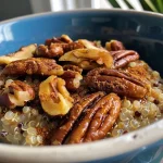 ['Close-up of a colorful Maple Pecan Quinoa Breakfast Bowl with toppings.', 'Side view of a hearty bowl filled with quinoa, oats, and pecans drizzled with maple syrup.', 'A delicious breakfast bowl showcasing quinoa, coconut flour, and toasted pecans.', 'Appetizing Maple Pecan Quinoa Breakfast Bowl featuring a mix of grains and nuts.']