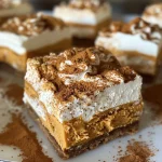 ['Close-up of creamy No-Bake Pumpkin Cheesecake Bars with a golden crust and whipped topping.', 'Side view of delicious No-Bake Pumpkin Cheesecake Bars showcasing layers and toppings.', 'A slice of No-Bake Pumpkin Cheesecake Bars adorned with whipped cream and spices.', 'Appetizing No-Bake Pumpkin Cheesecake Bars featuring a crust and smooth pumpkin filling.']