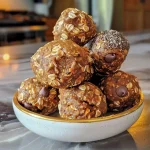 ['A close-up view of No Bake Pumpkin Spice Energy Bites arranged on a plate.', 'Side view of a cluster of No Bake Pumpkin Spice Energy Bites with a sprinkle of pumpkin pie spice.', 'Juicy and delicious No Bake Pumpkin Spice Energy Bites displayed in a rustic setting.', 'A vibrant plate of No Bake Pumpkin Spice Energy Bites, showcasing their texture and ingredients.']