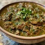 ['Close-up view of a bowl of Slow Cooker Beef Chile Verde with green sauce.', 'Juicy Beef Chile Verde served in a rustic bowl garnished with fresh cilantro and lime.', 'A side perspective of a hearty Slow Cooker Beef Chile Verde with toppings of avocado and carrots.', 'Delicious Slow Cooker Beef Chile Verde in a bowl, showcasing tender beef and vibrant green sauce.']