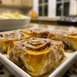 ['Close-up view of warm, golden-brown pumpkin cinnamon rolls drizzled with cream cheese icing.', 'Side shot of gooey brown butter pumpkin cinnamon rolls topped with a thick layer of white icing.', 'A tantalizing display of pumpkin cinnamon rolls with glistening icing and cinnamon dust.', 'Delicious, fluffy pumpkin cinnamon rolls highlighted by a creamy glaze and a sprinkle of cinnamon.']