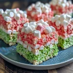 ['Close-up of vibrant Watermelon Krispie Treats, highlighting layers of red and green.', 'Side view image of Watermelon Krispie Treats, showcasing their texture and colors.', 'Detailed shot of colorful Watermelon Krispie Treats with chocolate chips sprinkled on top.', 'Close-up of Watermelon Krispie Treats displaying red and green coloration, resembling fruit.']